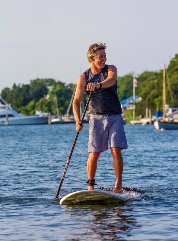 a man standing next to a body of water