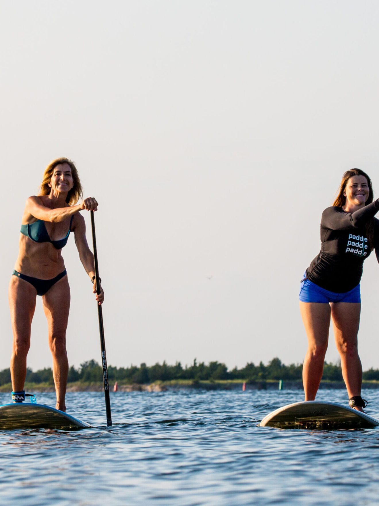 a group of people standing next to a body of water
