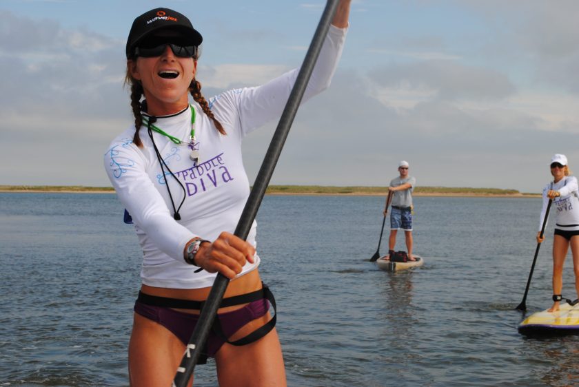 a person riding on the back of a boat in a body of water