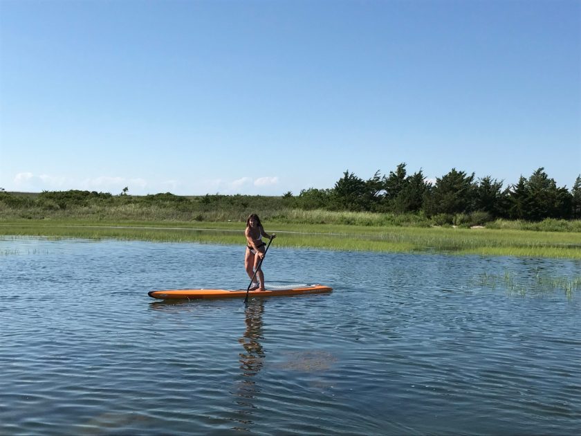 a man riding a board on a body of water