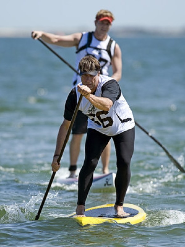 a man riding a wave on a surf board on a body of water