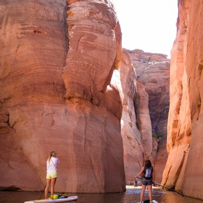 a group of people on a rock next to water