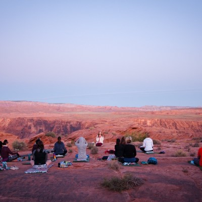 a group of people sitting at a beach