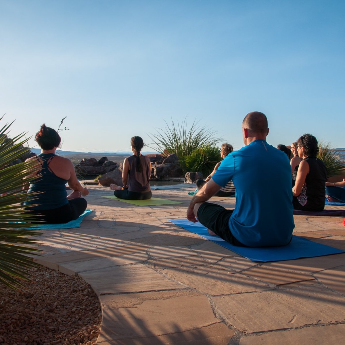 a group of people sitting at a beach