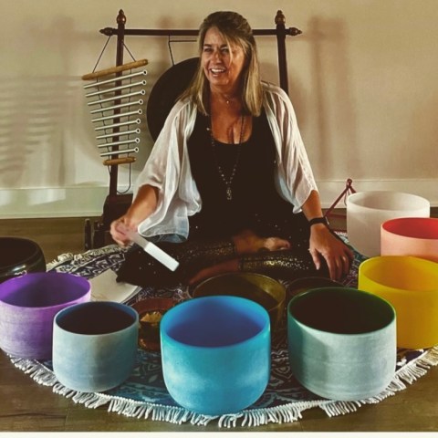 a person sitting at a table with a cup of coffee