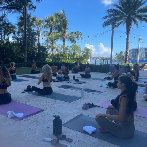 a group of people sitting at a beach