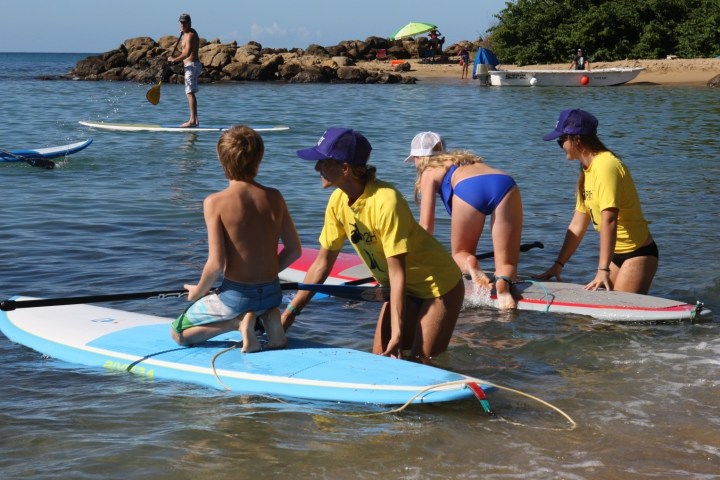 a group of people rowing a boat in the water